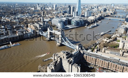 Aerial drone bird's eye view of iconic Tower Bridge, the Shard and skyline in City of London, United Kingdom