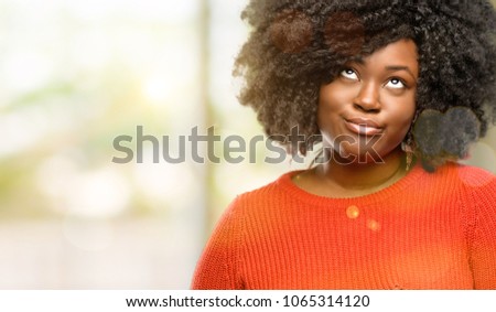 Beautiful african woman making funny face fooling, outdoor