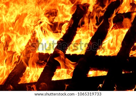 Burning fence, wood, chairs on belgium camping campfire, bonfire. Night, natural colors, detail