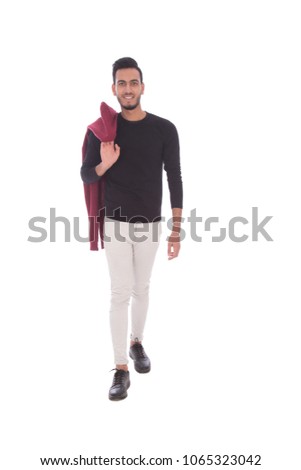 Full-length shot of a walking man hanging the jacket on the shoulder, isolated on a white background.