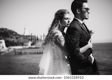 Beautiful wedding couple on their wedding photoshoot by the sea