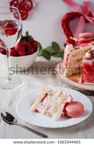 Delicious biscuit cake with strawberries on table