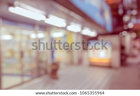 Abstract blur image of  Road and footpath in Night time with bokeh for background usage . (vintage tone)