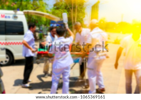 Blurred Medical commander of Emergency response team and rescue team save life the patient from car accident transfer moving to the ambulance,CPR training.