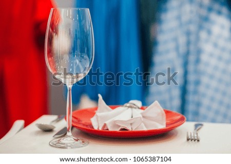 Beautiful table setting on a white background, plate, kettle, glasses and Cutlery