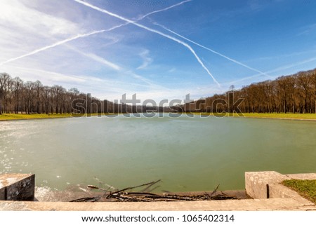 Long exposure photography of Autumn - winter in Lake in the Gardens of Palace of Versailles, Paris, France

