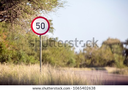 Speed limit 50 sign on the African road, safari park Kruger, Sou