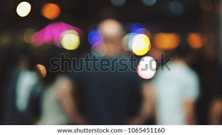Blurred background with bokeh defocused lights of diverse people or audience at music festival. Enjoy Music and Entertainment Concept. (Space for text or abstract background for design)