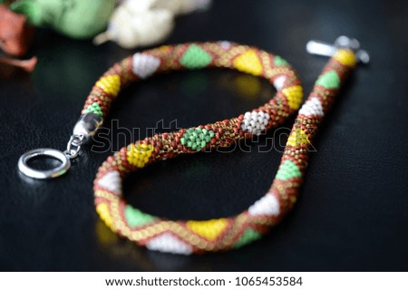 Ethnic style beaded necklace on a dark background close up