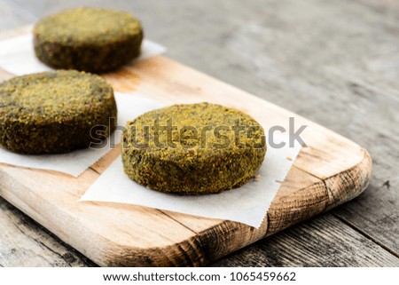 Grilled veggie hamburger with spinach and peas on wooden table