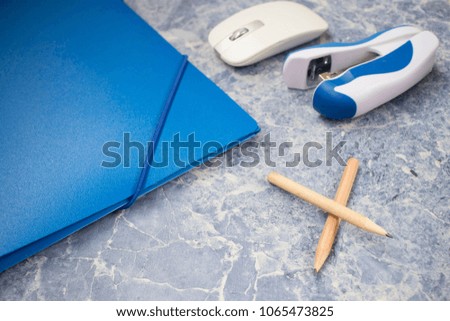 pencils, stapler, mouse, folder top view