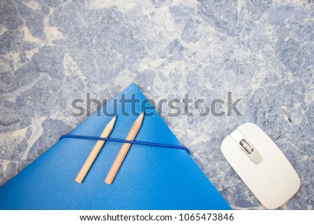file folder, mouse and pencil of contracts, business concept, background is a blue concrete