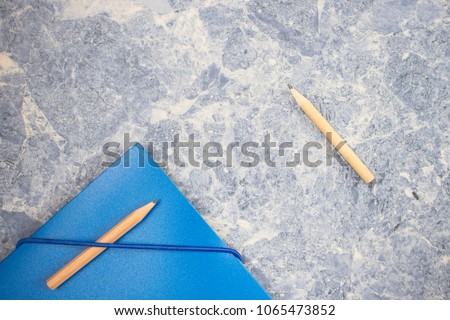 file folder and pencil of contracts, business concept, background is a blue concrete