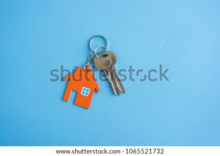House and key on blue background. Minimal creative style.