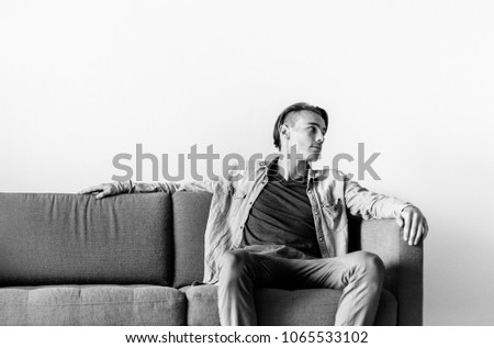 Young man sitting on sofa