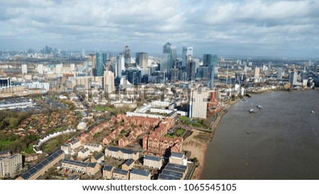 Aerial bird's eye view photo taken by drone of famous Canary Wharf skyscraper complex, Docklands, river Thames, Isle of Dogs, London, United Kingdom