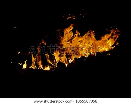Red and yellow fire flames with reflection on black background
