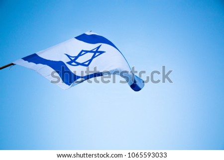 Israel flag waving  on the blue sky background