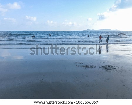 little girls playing at the beach