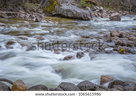 Long exposure of rocky river from water fall at Yosemite 