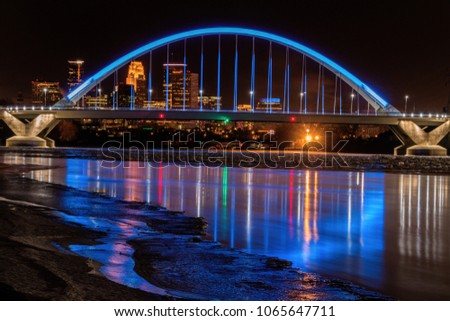 Lowry Bridge colored blue with Minneapolis Skyline behind