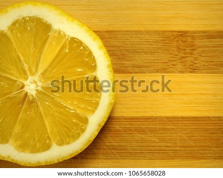 Lemon. Round juicy cut. Cutting board background