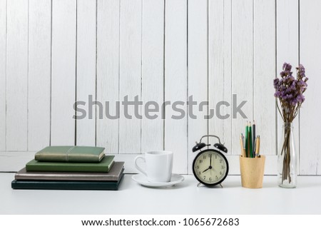 education workspace background concepts Pencil, stationery, coffee cup, flowers, Book, alarm clock White wooden vintage wall