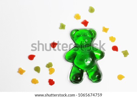 green jelly bear and little candy on white isolate