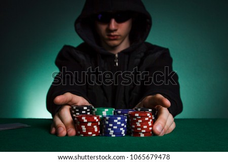 The guy in the black hood puts all the chips in poker