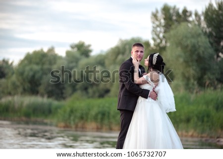 Photo session of a beautiful wedding couple on a boat dock