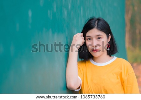 Portrait of beautiful asian chic girl pose for take a picture,Lifestyle of teen thailand people,Modern woman happy concept,Tennis course, pastel tone