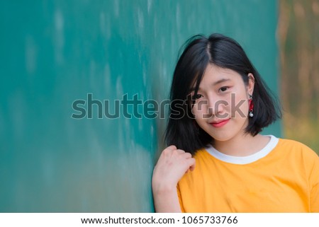 Portrait of beautiful asian chic girl pose for take a picture,Lifestyle of teen thailand people,Modern woman happy concept,Tennis couse, pastel tone