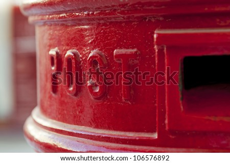 Close-up view of a red postbox, toned image.