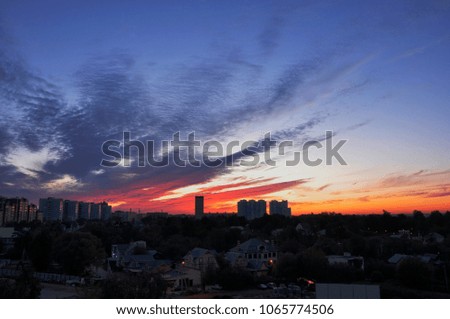 Bright colourful sunset in the urban city in summer. Panorama of the modern town