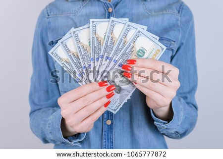 Red charity donate people person new tax currency exchange customer buyer lifestyle luxury transfer us give concept. Cropped close up photo of lady holding money in hands isolated on gray background