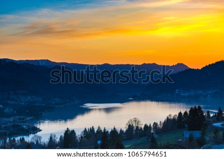 Amazing sunset at the Colibita lake in Carpathian Mountains, Romania