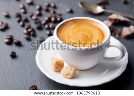 Cup of coffee on black slate background.  Close up.