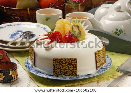 Fruit cake with tea on table