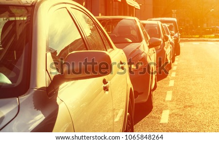 Some parked cars with the sun shining on them, transportation concept. Royalty-Free Stock Photo #1065848264