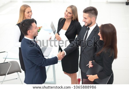 handshake of business partners after signing the contract