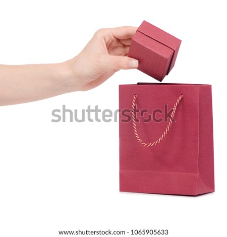 Box jewerly in hand put in bag package on a white background isolation