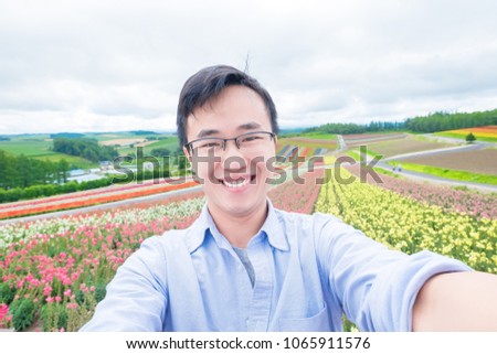man selfie happily with beautiful landscape in Shikisai-no-oka