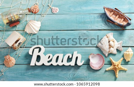 summer background with top view of beach accessories and letters on blue wooden board with copy space for own text
