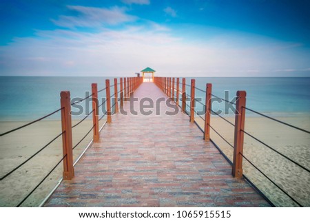 Beautiful tropical beach view with wooden jetty at Pinang National Park Kerachut beach Malaysia. Nature composition. Long Exposure