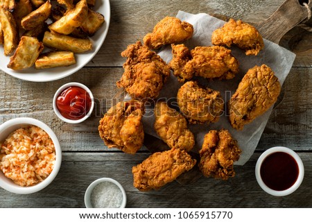 Delicious homemade crispy fried chicken with taters and coleslaw. Royalty-Free Stock Photo #1065915770