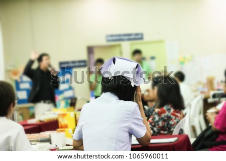 Back or rare view a nurse on blur background group of people in hospital event