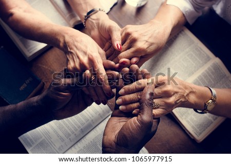 Group of people holding hands praying worship believe Royalty-Free Stock Photo #1065977915