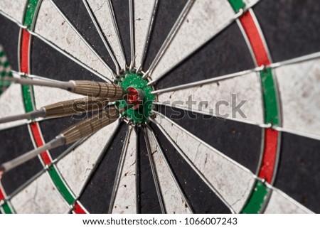 bull's eye, darts in the center,