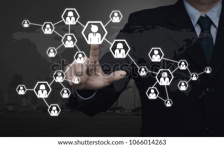 Businessman pressing network icon over digital dot world map and city tower, Communication business concept, Elements of this image furnished by NASA
