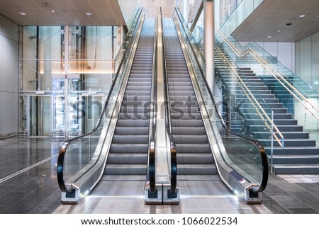 Modern luxury escalators with staircase at airport Royalty-Free Stock Photo #1066022534